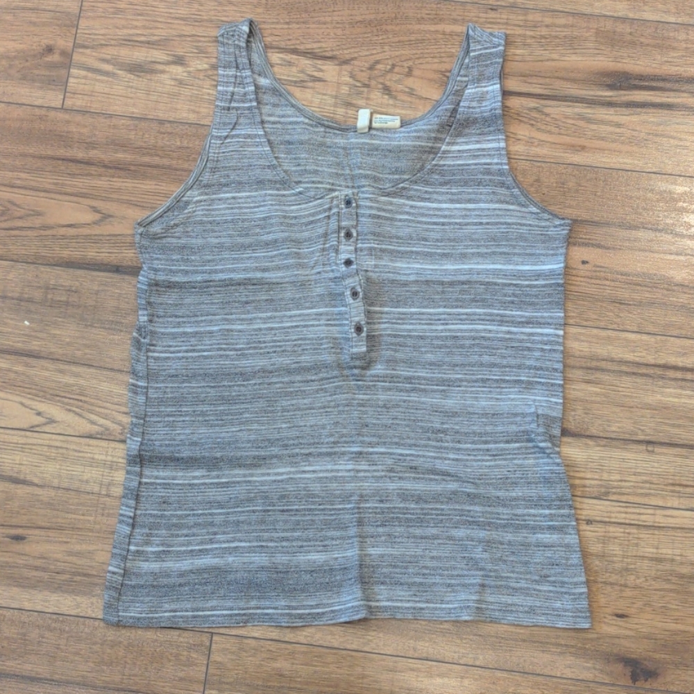 Covet tank top. Fits more like a looser small.